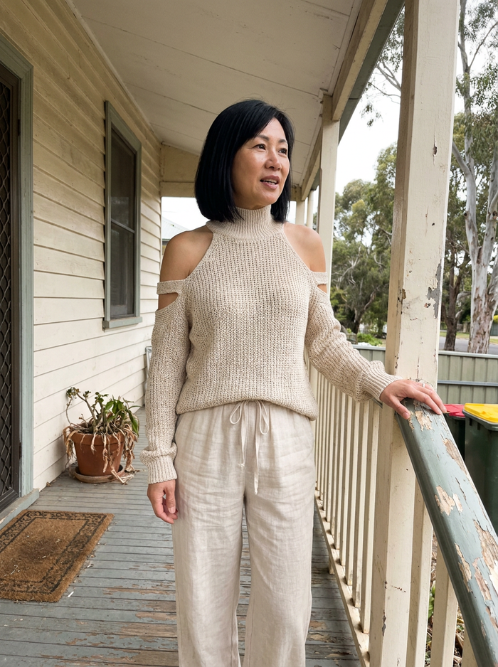 Woman wearing the Questa knit top and wide leg set on a verandah