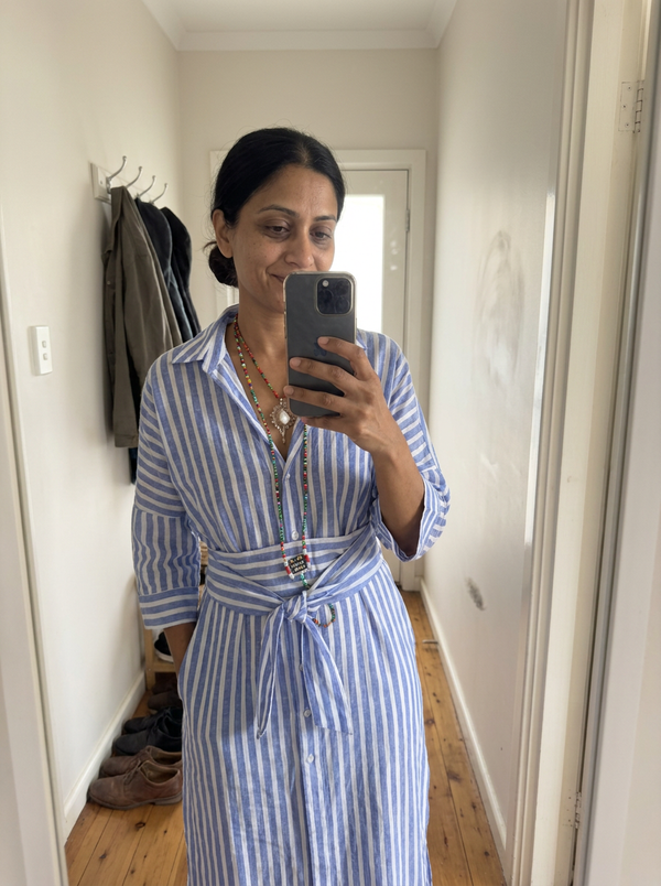 Woman wearing the Noa striped shirt dress, hallway mirror
