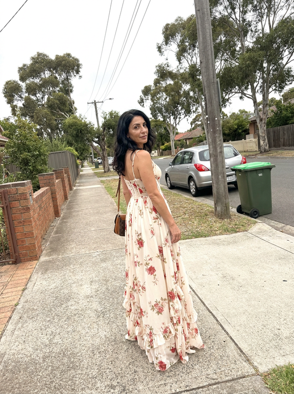 Woman wearing the Scarlett floral maxi dress on a suburban street