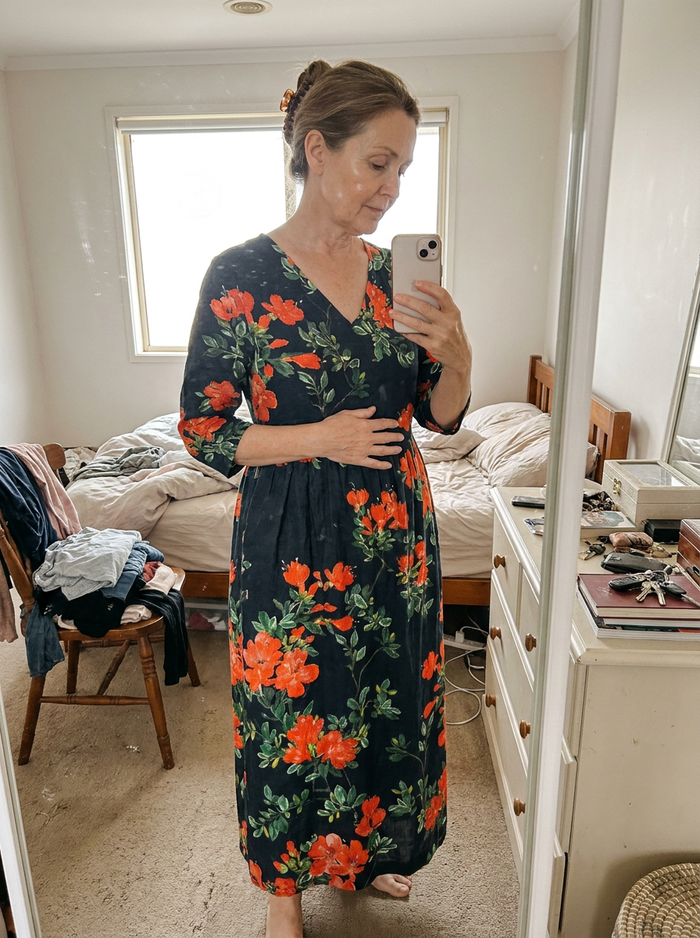 Woman wearing the Cyrus floral midi dress, bedroom mirror