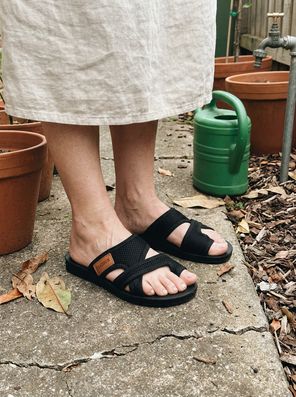 Close view of the Natalie orthopedic sandals on a garden path